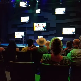 a group of people watching tvs