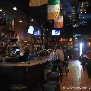 a bar with people sitting at the bar