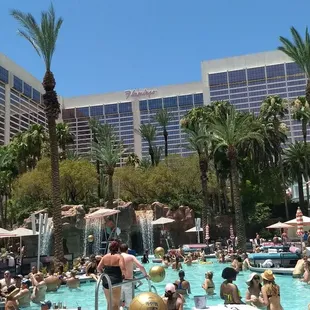 Flamingo pool party with private daybed, hostess, waterslides and waterfall. Truly sublime!