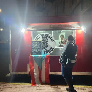 a man standing in front of a food truck