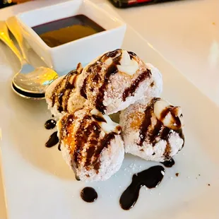 three donuts with chocolate sauce