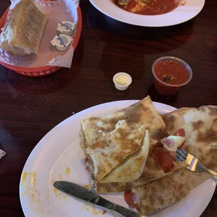 a plate of quesadillas and salsa