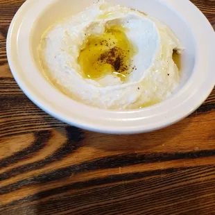 a bowl of hummusle with olive oil