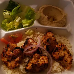 Chicken kabobs,  rice, and hummus.