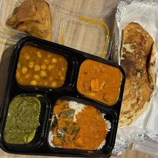 Basmati rice, butter chicken, chickpeas, spinach with cottage cheese cubes, spicy eggplant, and garlic naan