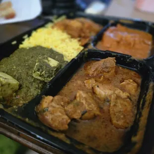 Combo plate with spicy fish and chicken curry, palak paneer and mushroom veggies sides