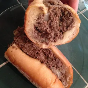 a hand holding a sandwich