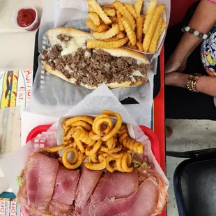 Laspadas Famous (small) with curly fries and small Cheesesteak with French fries