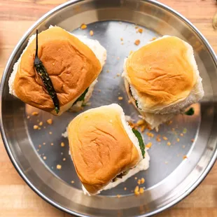 Our popular Vada Pav, potato-patty sliders with our flavorful house-made chutneys