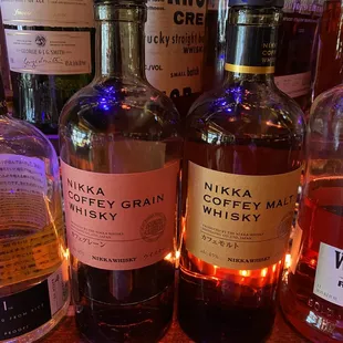 bottles of whiskey on a bar shelf