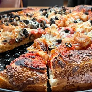 Olive and cheese pizza - medium thick crust. Sesame seeds come standard on the crust.