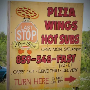 a sign for the last stop pizza shop