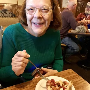 a woman eating a piece of pie