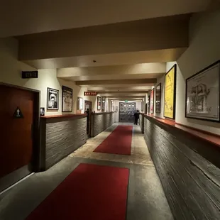 a long hallway with a red carpet
