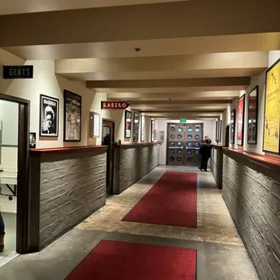 a long hallway with a red carpet