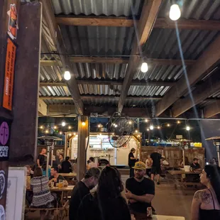 Back patio and food truck. There&apos;s a bar inside and on the patio.