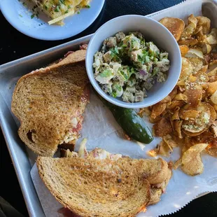 The Reuben - served with housemade chips (garlic+parmesan) and a pickle. The potato salad is added.