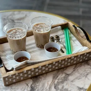 wo cups of coffee on a tray