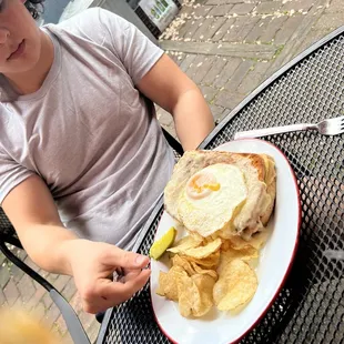 a man sitting at a table with a plate of food