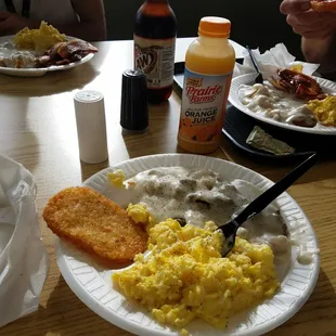 a plate of food with eggs, sausage, and gravy