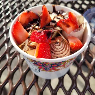 Brownie ice cream with strawberries, almonds &amp; chocolate drizzle.