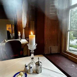 a table with a candle, salt and pepper shakers