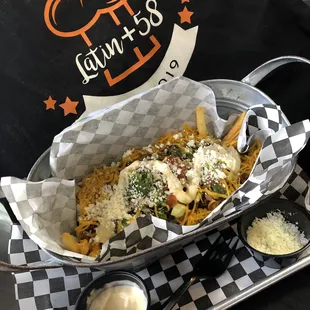 French fries with beef, cheese, cream and pico de Gallo salad.