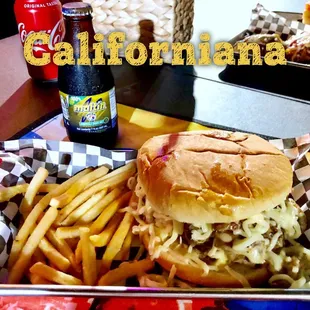 Gourmet hamburger with mushrooms, cheese and a special sauce, French fries and Malta (Venezuelan drink)