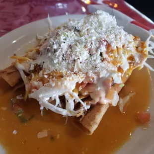 Tacos Dorado (Chicken). It was like rolled tacos, topped with a savory cabbage, salsa and cheese and sauce.