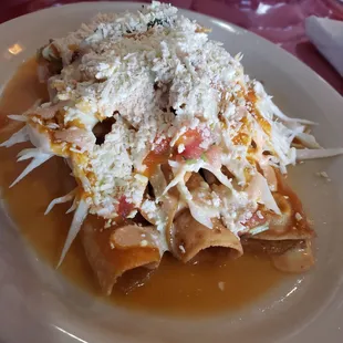 Tacos Dorado (Chicken). It was like rolled tacos, topped with a savory cabbage, salsa and cheese and sauce.