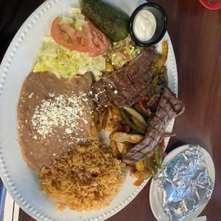 Carna  asada authentic and sundried. Steak and chicken rice and beans, grilled jalapeño, home made guacamole and sour cream. All included