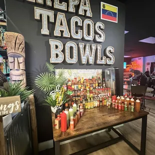 a table full of tacos and sauces