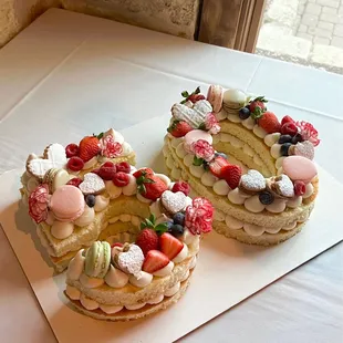 two cakes with fruit toppings