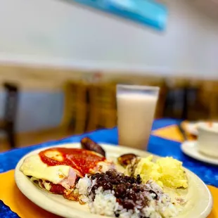 Chicken Milenesa with black beans, white rice, plantains and mashed potatoes.