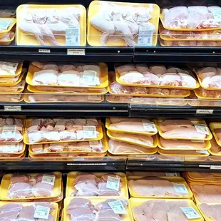 a display of meat in plastic containers