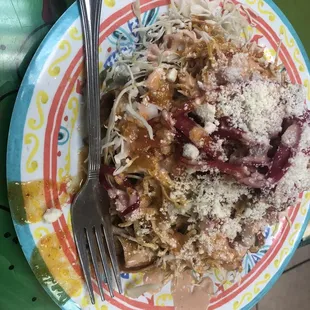 a colorful plate of food with a fork