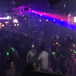 a crowd of people dancing at a nightclub