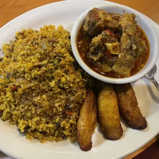 Oxtails, pinto beans, and yellow rice, and plantains.