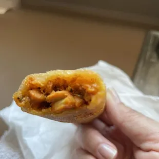 a hand holding a piece of food