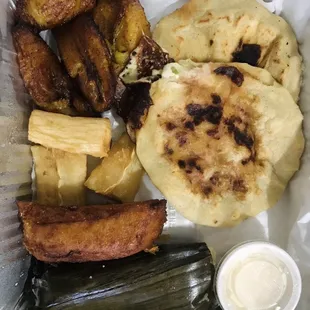 Bandeja Tipica Salvadorena - 2 pupusas, plantains, cassava root, chicken tamale, sweet corn tamale, and a Salvadoran Enchilada (separate)