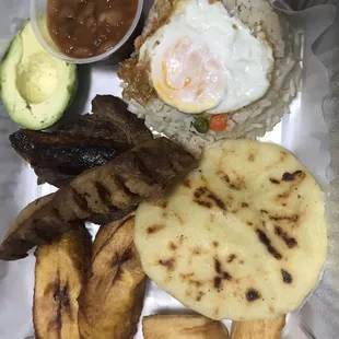 Bandeja Paisa (grilled steak, sausage, fried pork belly, beans, arepa, avocado, yuca/cassava, rice w/ vegetables, fried egg, &amp; plantains)