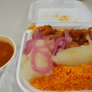 deliciously seasoned pork, yuca and onions, yellow rice and red beans.