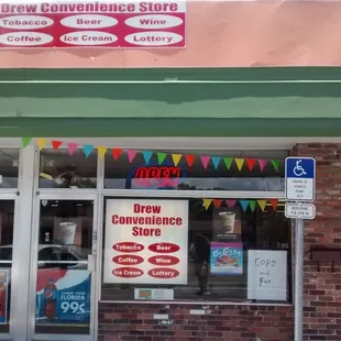 a storefront with a sign for a new convenience store