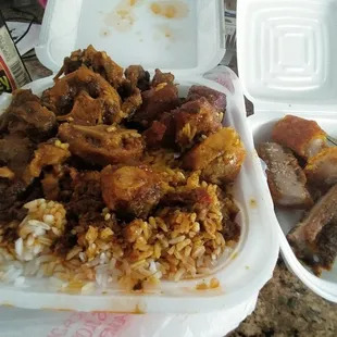 perfectly seasoned oxtails with white rice and sweet golden fried plantians and gravy with a side of very delicious fried pork belly
