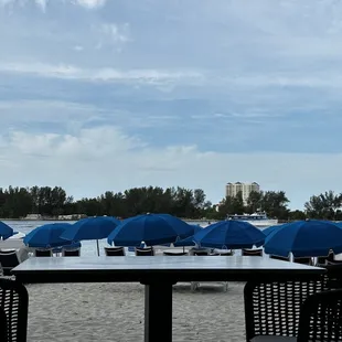 a view of a beach with chairs and umbrellas