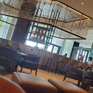 a restaurant with a large chandelier hanging from the ceiling