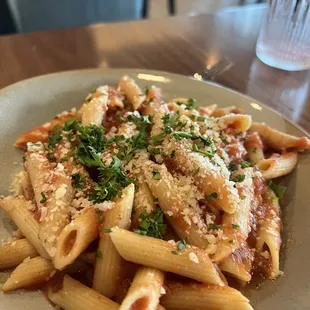 a plate of pasta with parmesan cheese and parsley