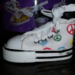 a pair of sneakers with peace signs painted on them