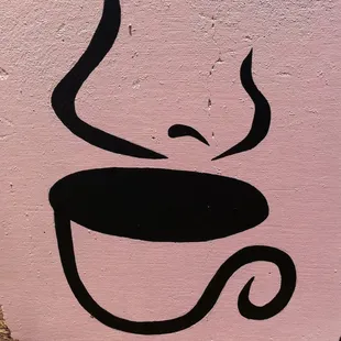 a coffee cup painted on a wall