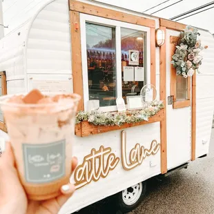 a hand holding a cup of coffee